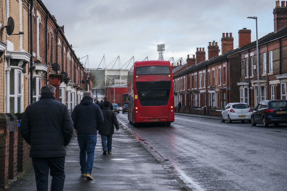 A city bus on a Liverpool street on the way to the ground